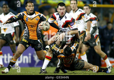 Bradford Bulls' Michael Withers (C) is tackled by West Tigers' Bronson Harrison and Ryan O'Hara (bottom) during the Carnegie World Club Challenge at the Galpharm Stadium, Huddersfield, Friday February 3, 2006. PRESS ASSOCIATION Photo. Photo credit should read: Gareth Copley/PA. Stock Photo