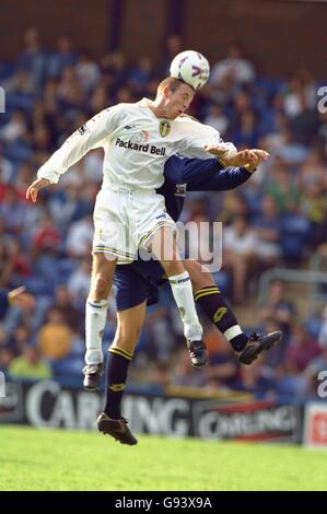 Soccer - FA Carling Premiership - Wimbledon v Leeds United. Wimbledon's Andy Roberts challenges Leeds United's Lee Bowyer for the ball. Stock Photo