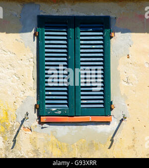 Closed wooden window with wind shutters in brown timbered house Stock ...