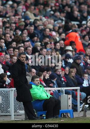 Chelsea manager Jose Mourinho watches the action from the touchline as his team look for a way back into the game Stock Photo