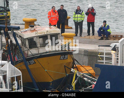 The Rising Sun fishing boat sits on board the Granuaile salvage ship, Tuesday February 7 2006, after divers worked through the night to recover the wreck which sank six miles from Kilmore Quay in Wexford in December 2005. The lobster boat, which sank last November with the loss of two crew, is taken to near Rosslare Port, by the Irish Lights vessel the Granuaile, where it will be held overnight. See SEA Salvage. PRESS ASSOCIATION Photo. Photo credit should read: Niall Carson/PA Stock Photo