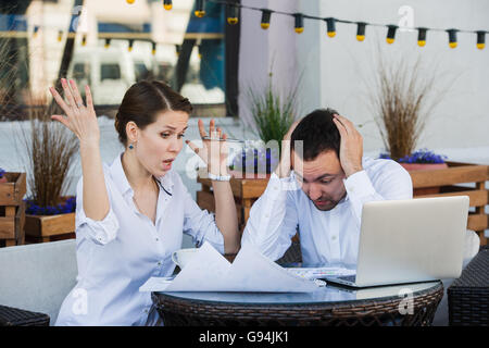 business people conflict working problem, angry boss argue scream to colleague businessmen and women serious argument negative emotion discussing report meeting at outdoors cafe during the lunch break Stock Photo