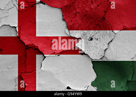 flags of England and Hungary painted on cracked wall Stock Photo