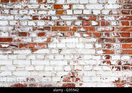 vintage red brick wall painted white with peeling off paint Stock Photo