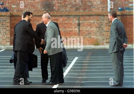 Sir Bobby Charlton greets the FIFA Inspection Team while Manchester United manager Sir Alex Ferguson (right) waits in the background Stock Photo