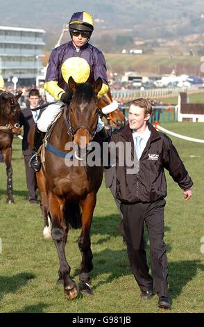 Horse Racing - Cheltenham Festival - Queen Mother Champion Chase Day - Cheltenham Racecourse. Mister McGoldrick ridden by Dominic Elsworth is lead to post in The Queen Mother Champion Steeple Chase (Class 1) Stock Photo