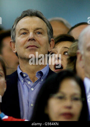 British Prime Minister Tony Blair and wife Cherie stand for the national anthem during the triple jump medal ceremony at the Melbourne Cricket Ground on the penultimate day of the Commonwealth Games, Saturday March 25, 2006. Mr Blair and wife Cherie landed in Australia earlier today after a record breaking flight across the world. Their chartered British Airways 777 jet registered the longest non-stop passenger flight by any aircraft, taking 18 hours and 55 minutes to make the 9,200 nautical mile journey from Brussels to Australia. See PA story POLITICS Blair. PRESS ASSOCIATION photo. Photo Stock Photo