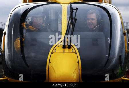 Scottish Health Minister Andy Kerr (right) sits inside the cockpit of an EC135 Eurocopter helicopter at Edinburgh Airport, Monday March 20, 2006, on the day he formally took delivery of two fixed wing King Air 200c air ambulances that will form an integral part of a new world class air ambulance service for Scotland. With a range of nearly 1,700 miles, a top speed of 289 knots and space for two stretchers, they are due to start operating out of Glasgow and Aberdeen from April 1. See PA Story SCOTLAND Ambulance. PRESS ASSOCIATION Photo. Photo credit should read: Andrew Milligan/PA. Stock Photo