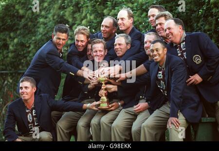 The USA team all want a touch of the Ryder Cup, as they form a celebratory team group Stock Photo