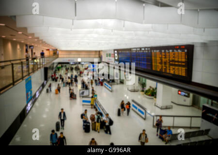 Passengers at airport arrival gate waiting and leaving - blurred Stock Photo