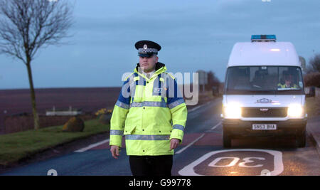 A police officer stands at the edge of a 3km 'protection zone' round Cellardyke, Fife, Thursday April 6, 2006, after samples from a dead swan found in the small coastal town tested positive for 'highly pathogenic H5 avian flu'. Scientists are now waiting to see if the strain was the deadly H5N1, which can be fatal to humans if they come into close contact with birds. See PA story HEALTH BirdFlu. Stock Photo