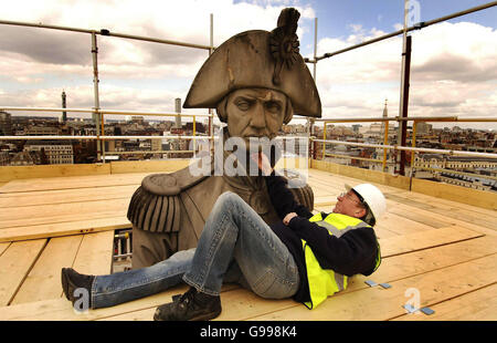 Bob Egan, supervisor of the cleaning and restoration team, inspects the damaged face of Lord Horatio Nelson on Nelson's Column in Trafalgar Square, London. Stock Photo