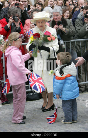 Britain's Queen Elizabeth II receives flowers during her walk-about in Guildford High Street after distributing Maundy Money at Guildford Cathedral. Stock Photo