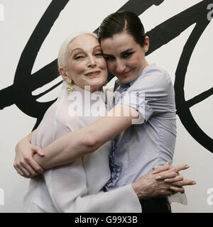 Model Carmen Dell'Orefice and model Erin O'Connor pose at the opening of David Downton haute couture painting exhibition at the London College of Fashion in London. Stock Photo