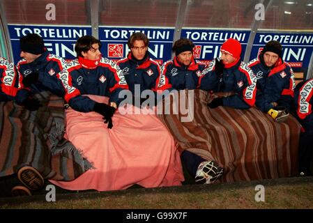 Italian Soccer - Serie A - Piacenza v Udinese. Piacenza's substitutes try to keep warm on the bench Stock Photo