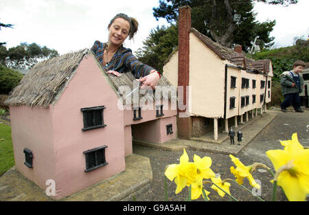 Maria Neil trims a thatched roof during her annual spring clean at Southsea Model Village in Portsmouth as they prepare for the Easter holidays and their first busy weekend of the year. Stock Photo