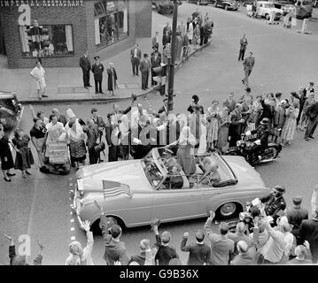 US President Dwight Eisenhower (standing) waves to the crowds on Fleet Street as he is driven to St Paul's Cathedral with British Prime Minister Harold MacMillan (seated in back seat) Stock Photo