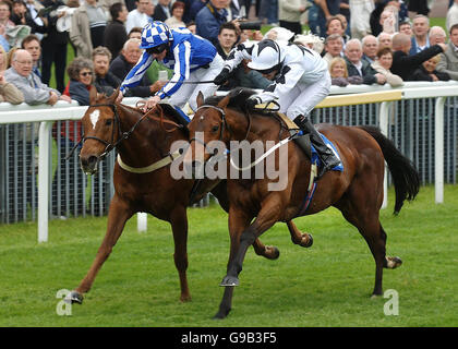 Blue Spinnaker ridden by jockey Paul Mulrennan (nearside) wins ahead of Look Again ridden by jockey Paul Hanagan in the Newton Investment Management Handicap at York racecourse. Stock Photo