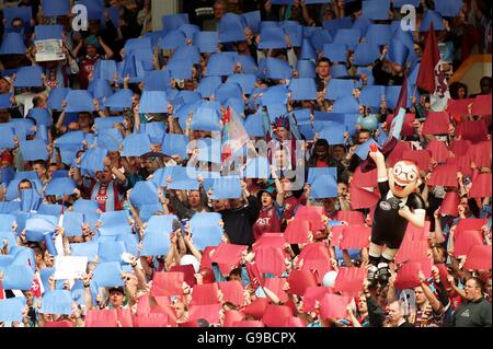 Aston Villa fans hold up pieces of card in the club colours Stock Photo