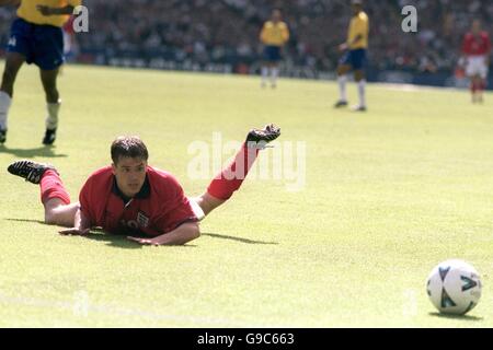 England's Michael Owen watches the ball go out of play after going down while attempting to round Brazil goalkeeper Dida Stock Photo