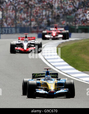 Spain's Fernando Alonso in his Renault leads McLaren-Mercedes' Kimi Raikkonen (second) and Ferrari's Michael Schumacher (top) out of Stowe during the British Grand Prix at Silverstone. Stock Photo