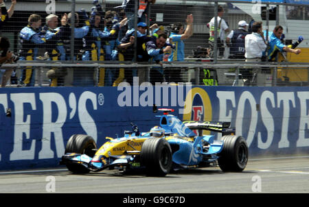 Spain's Fernando Alonso in his Renault celebrates with his team (top) after winning the British Grand Prix at Silverstone. Stock Photo