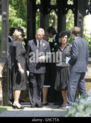 The Prince of Wales and the Duchess of Cornwall talk with Annabel Elliot (left) and Tom Parker Bowles before the funeral of the Duchess' father Major Bruce Shand at Holy Trinity church in Blandford. Stock Photo