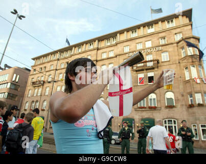 England football fans celebrate outside the team hotel in Nuremberg, Germany, ahead of England's second World Cup game against Trinidad and Tobago tomorrow. Stock Photo