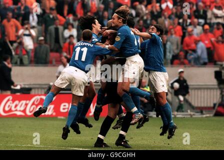Italy goalkeeper Francesco Toldo is mobbed by his teammates after his penalty shoot-out saves earned them a place in the final Stock Photo