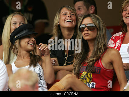 Cheryl Tweedy (black hat), partner of Ashley Cole, Coleen McLoughlin (centre) girlfriend of Wayne Rooney and Victoria Beckham (sunglasses), wife of David Beckham in the stands ahead of the FIFA World Cup Group B match between England and Trinidad and Tobago at the Franken-Stadion, Nuremberg, Germany. Stock Photo