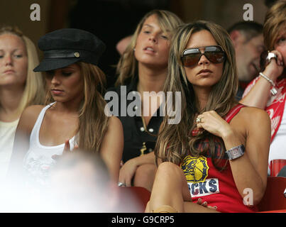 Cheryl Tweedy (black hat), partner of Ashley Cole, Coleen McLoughlin (centre) girlfriend of Wayne Rooney and Victoria Beckham (sunglasses), wife of David Beckham in the stands ahead of the FIFA World Cup Group B match between England and Trinidad and Tobago at the Franken-Stadion, Nuremberg, Germany. Stock Photo
