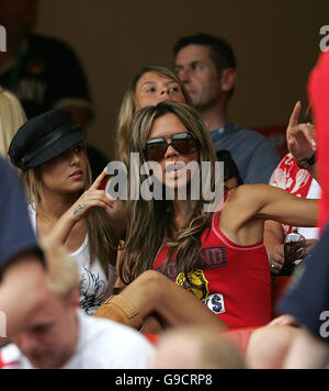 Cheryl Tweedy (left), partner of Ashley Cole, and Victoria Beckham (sunglasses), wife of David Beckham in the stands ahead of the FIFA World Cup Group B match between England and Trinidad and Tobago at the Franken-Stadion, Nuremberg, Germany. Stock Photo