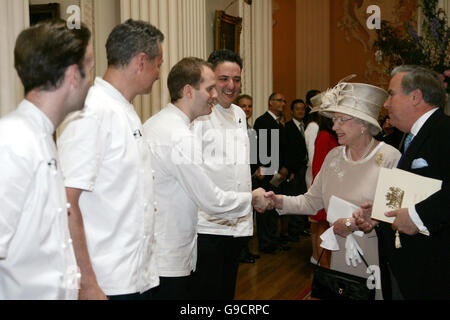 Left to right: Chefs who created the 'Great British Menu' served at a luncheon, hosted by the Lord Mayor: Marcus Wareing, dessert course, Nick Nairn, main course, Bryn Williams, fish course and Richard Corrigan, who designed the starter course meeting Britains Queen Elizabeth II and the Lord Mayor of London. Stock Photo