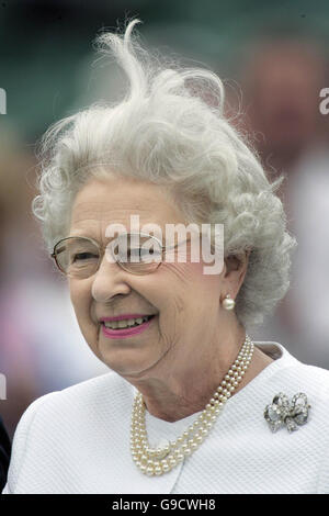 A gust of wind catches Britain's Queen Elizabeth II as she makes presentation to the Dubai team after they beat the Broncos 12 to 10 in the Queen's Cup Final at the Guards Polo Club, Windsor Great Park. Stock Photo