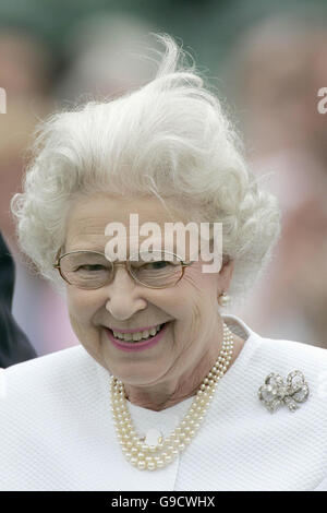 A gust of wind catches Britain's Queen Elizabeth II as she makes presentation to the Dubai team after they beat the Broncos 12 to 10 in the Queen's Cup Final at the Guards Polo Club, Windsor Great Park. Stock Photo