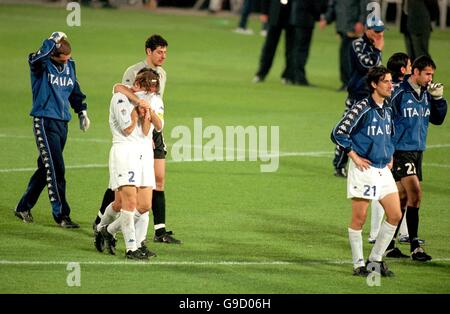 Italy's Francesco Totti (l) walks off in tears with his teammates after France scored the winning goal in golden goal extra time Stock Photo