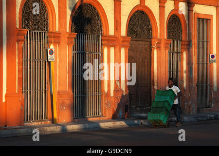 Local man transporting crates, historic centre, Havana, Cuba Stock Photo