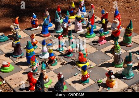 Colorful gnomes on checkerboard in outdoor setting in the quirky Gnomesville forest in Wellington Mill, Western Australia. Stock Photo