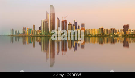 View of Abu Dhabi Skyline at sunset, United Arab Emirates Stock Photo