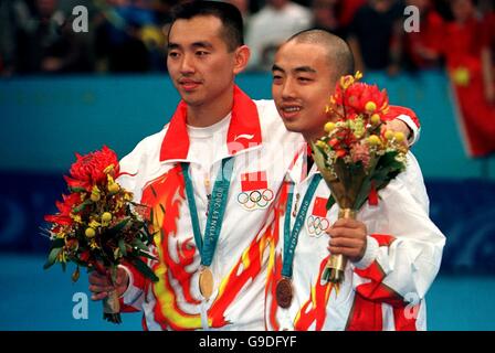 (l-r) China's Linghui Kong, Gold, and China's Guoliang Liu, Bronze stand together at the podium Stock Photo