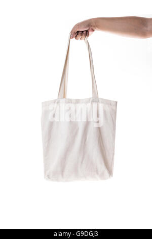 Hand holding cotton eco bag on white background Stock Photo