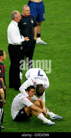 England's Frank Lampard who missed a penalty sits is consoled by David Beckham after penalty shoot-out defeat against Portugal in the Quarter Final match at the FIFA World Cup Stadium in Gelsenkirchen, Germany. Picture date: Saturday July 1, 2006. Photo credit should read: Nick Potts/PA. Stock Photo