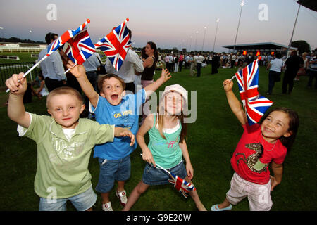 Horse Racing - Best of British Evening - Kempton Park Racecourse. Kids wave their 'Best of British' flags Stock Photo