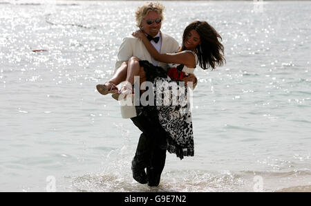 Virgin Atlantic boss Sir Richard Branson carries Italian actress Caterina Murino, who plays Solange in the upcoming James Bond film, Casino Royale, ashore in Montego Bay, Jamaica, on the airline's inaugural trip to the isle. It was announced today that Branson is to have a cameo role in the film. Stock Photo