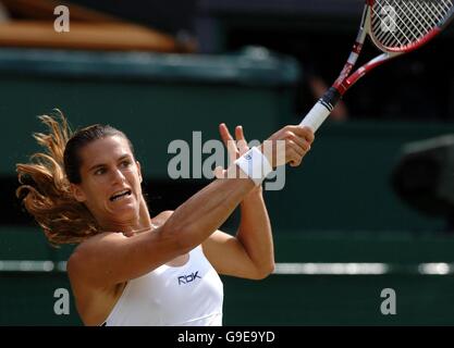 France's Amelie Mauresmo in action against Belgium's Justine Henin-Hardenne during the Ladies' singles final at The All England Lawn Tennis Championships at Wimbledon. Stock Photo
