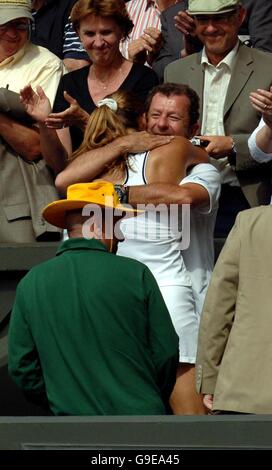 France's Amelie Mauresmo celebrates with coach Loic Counteau after her victory against Belgium's Justine Henin-Hardenne in the Ladies' singles final at The All England Lawn Tennis Championships at Wimbledon. Stock Photo