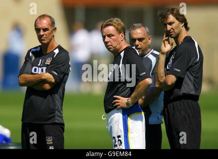 Portsmouth's manager Harry Redknapp (centre) with his new assistant Tony Adams (right), coach Joe Jordan (left) and technical director Avram Grant during a training session at the Wellington Sports Ground, near Southampton. Stock Photo