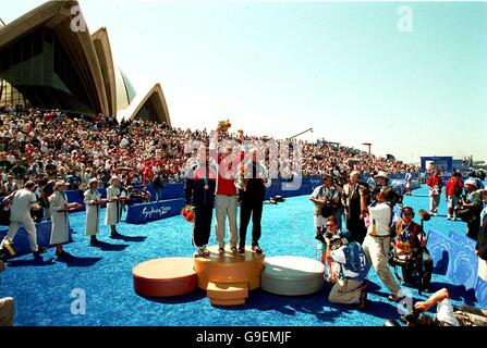 Sydney 2000 Olympics -Men's Triathlon. The triathlon medal winners stand on the podium outside the sydney opera house Stock Photo