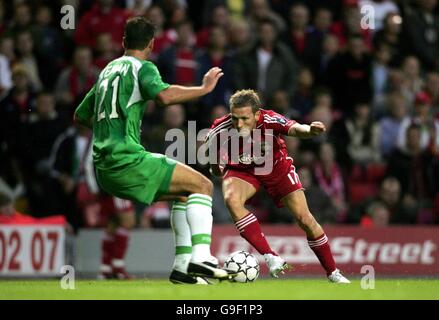 Liverpool's Craig Bellamy (R) gets past Maccabi Haifa's Dakel Keinan during a Champions League third qualifying round, first leg match at Anfield, Liverpool. Stock Photo