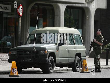 Soldiers patrol the streets around the Mansion House in Dublin city centre While a special unit conducts a search for a suspect device. Stock Photo